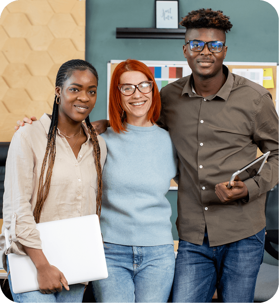 Three colleagues standing together smiling at the camera